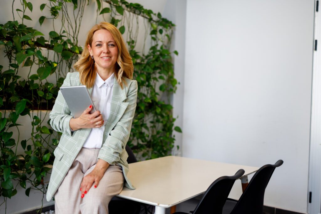 Professional woman smiling in green blazer